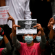 Protesters hold placards during a demonstration against the military coup in Yangon on February 6, 2021.